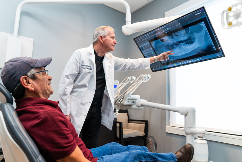 doctor showing dental procedure information within the dental center