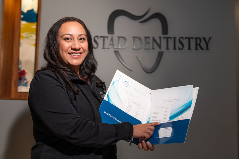 patient holding folder with dental finance & programs for treatments